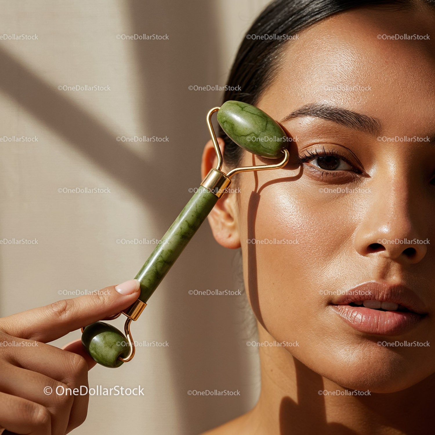 Young Woman Using Jade Facial Roller for Skin Care and Relaxation