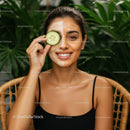 Young Woman Relaxing with Face Mask and Cucumber in Natural Setting