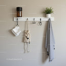 Minimalist Coat Rack with Green Plants and Wall Hooks for Modern Home