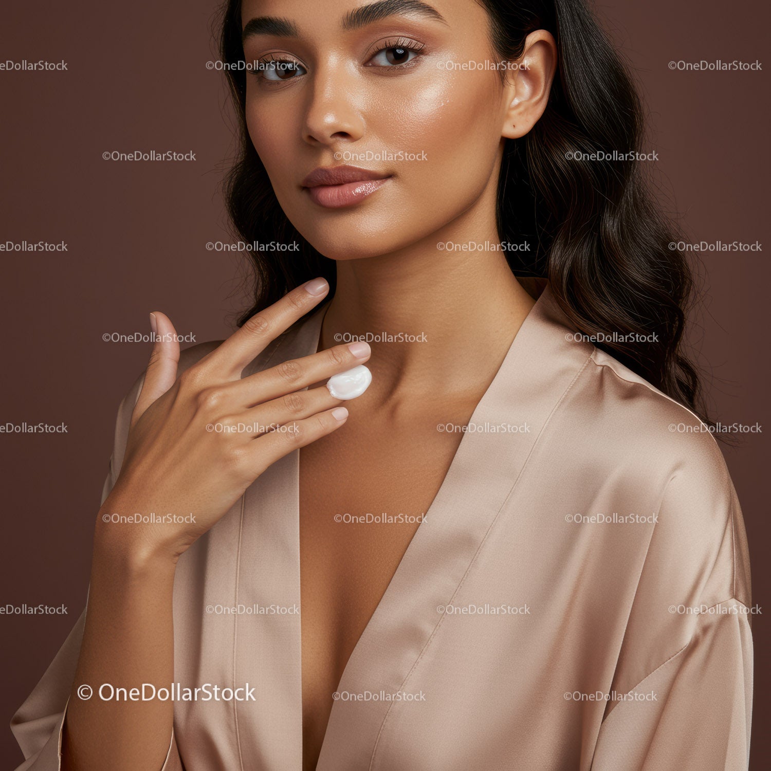 Elegant Woman with Glowing Skin Applying Skincare Cream