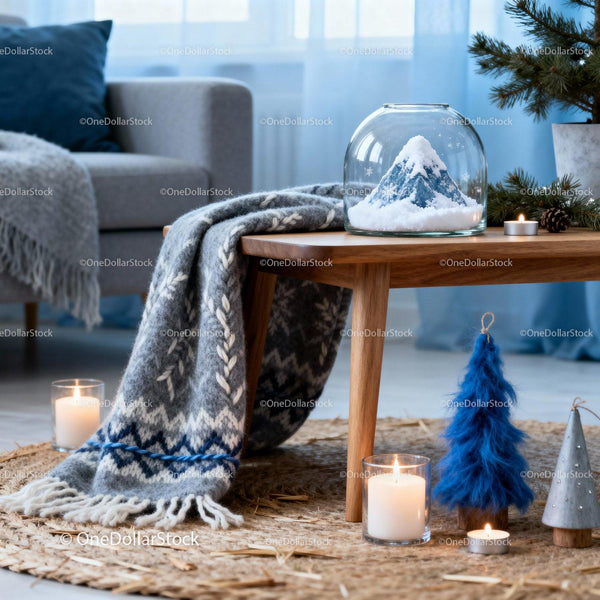 Cozy winter decor with knit blanket and snowy mountain globe