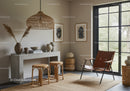 Modern living room with rattan stools and leather chair
