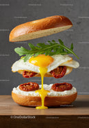 Delicious fried egg sandwich with sun-dried tomatoes and arugula