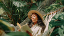 Woman Relaxing in Hammock Reading Book amid Tropical Greenery