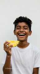 Smiling Boy Holding Pineapple with Bright Joyful Expression