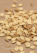 Close up of oat and wheat grains on brown surface