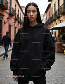 Fashionable Woman Wearing Black Hoodie in Urban City Street