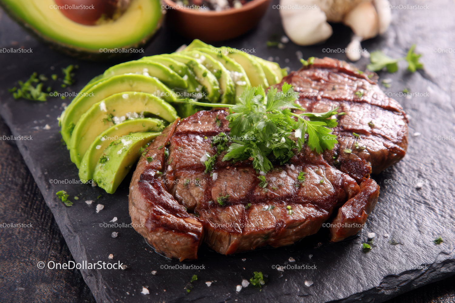 Juicy Grilled Steak with Sliced Avocado and Fresh Parsley