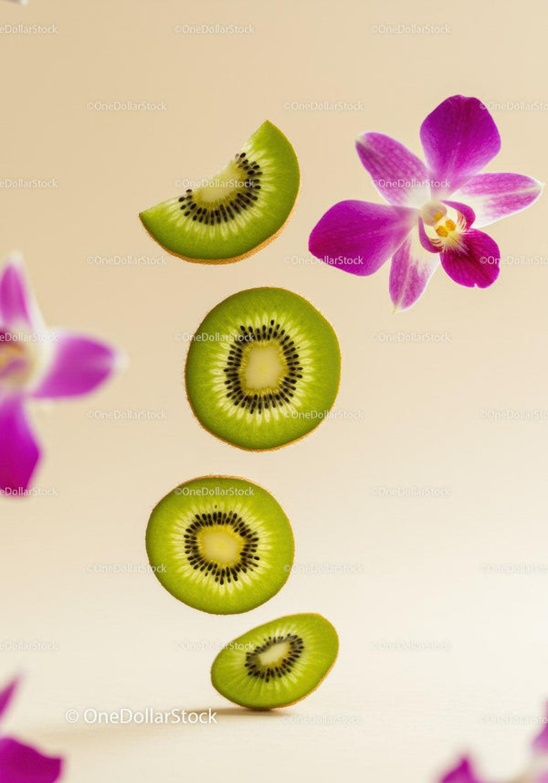 Fresh kiwi slices arranged with vibrant orchid flowers