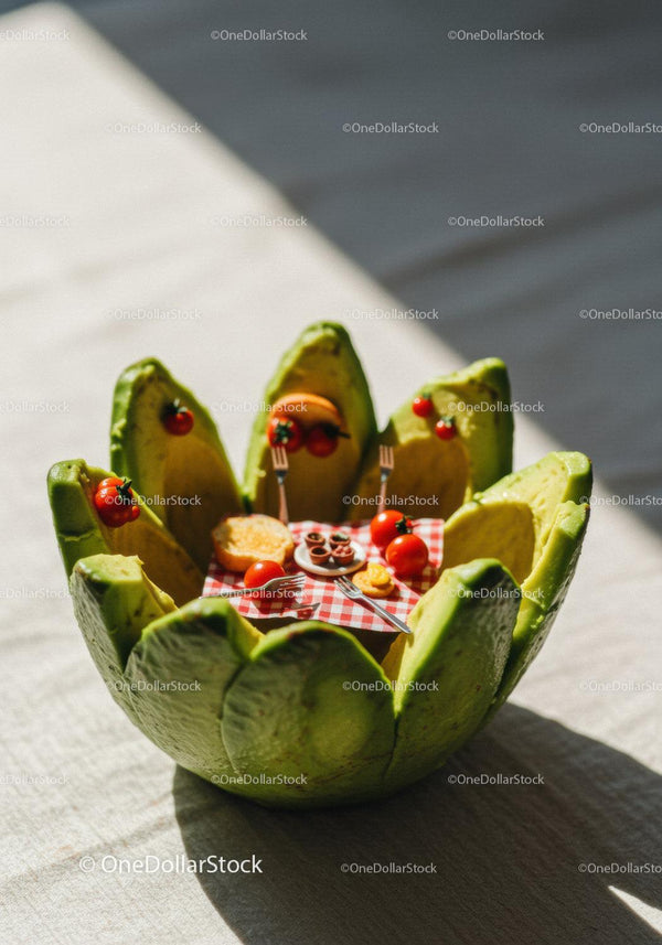 Miniature picnic set inside sliced avocado bowl