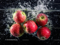 Vibrant Red Apples Splashing into Water
