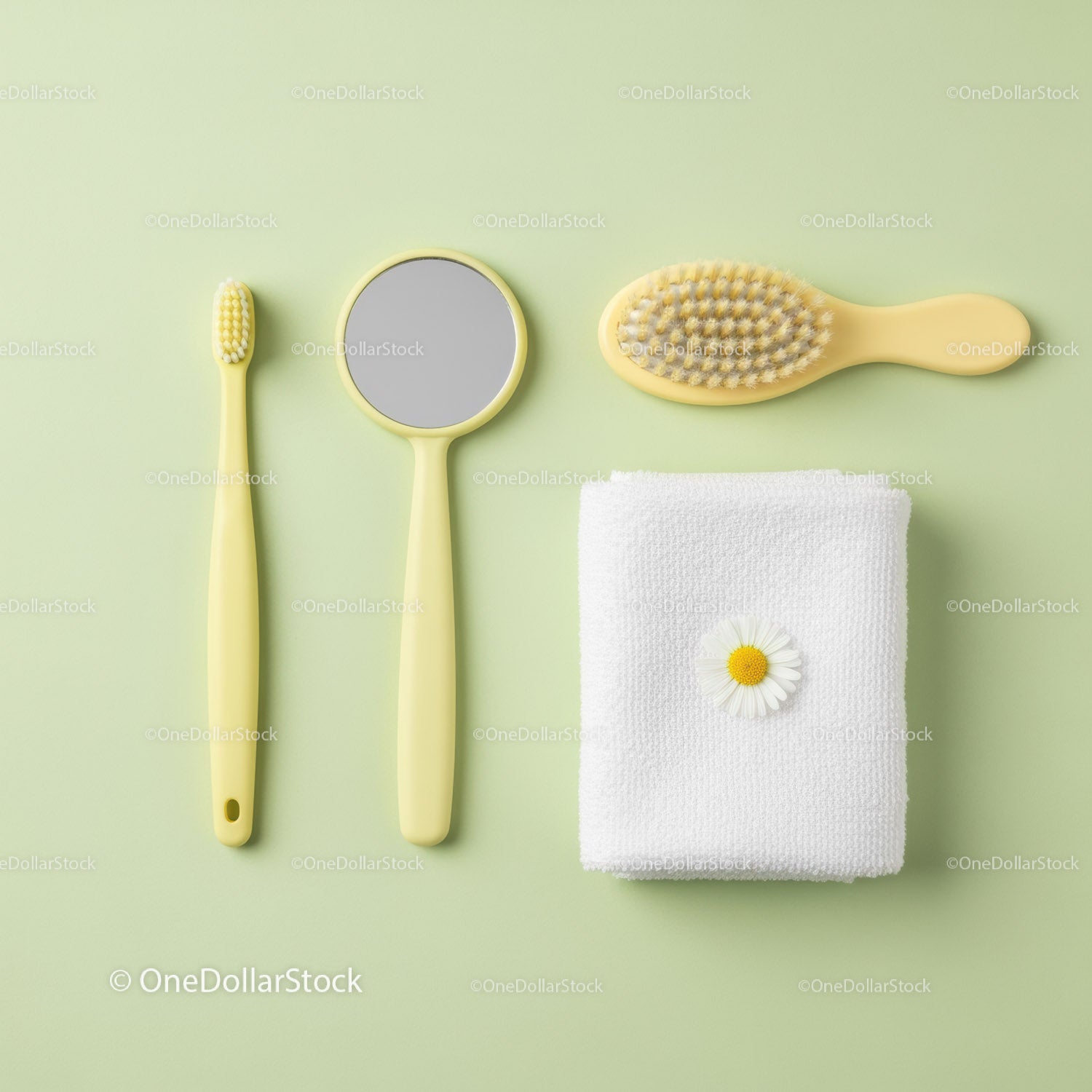 Yellow bathroom accessories with white towel and flower