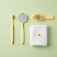 Yellow bathroom accessories with white towel and flower