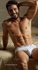 Smiling athletic man relaxing on bed in white underwear