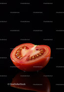 Fresh Half Tomato with Juicy Interior on Black Background
