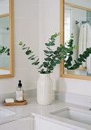 Elegant Bathroom with Green Eucalyptus in White Vase and Mirrors