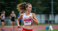 Young Female Sprinter Running During Track and Field Event