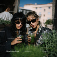 Fashionable Women Drinking Green Juice on Urban Rooftop