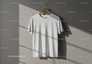 Minimalist white t-shirt hanging in natural sunlight
