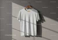 Minimalist white t-shirt hanging in natural sunlight