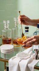 Elegant Cocktail with Lemon Twist in a Stylish Bar Setting