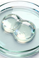Clear gel droplet on transparent glass surface
