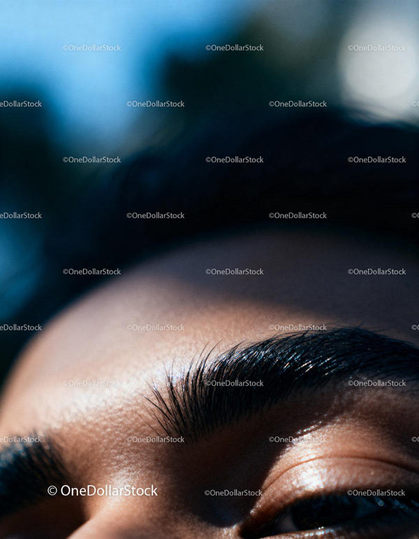 Close up of thick eyebrows and skin texture in natural light
