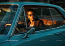 Stylish Man in Black Blazer Sitting in Vintage Blue Car at Sunset
