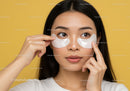 Young Woman Applying Under-Eye Patches for Skin Rejuvenation
