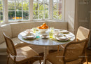 Sunlit breakfast nook with cozy seating and fresh oranges