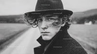 Black Hat Rainy Day Portrait of a Young Man in Moody Outdoor Scene