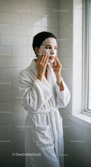Woman Applying Skin Mask in Bathroom for Beauty and Rejuvenation