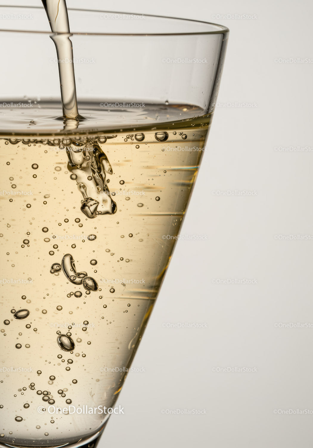Bubbly Champagne Pour in Clear Glass Close Up