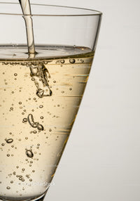 Bubbly Champagne Pour in Clear Glass Close Up