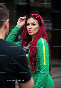 Vibrant Red Hair Woman in Green Tracksuit with Sunglasses in City
