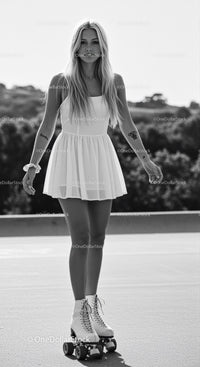 Young Woman Skating Outdoors in Vintage Style Dress