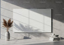 Blank white canvas on concrete wall with dried plants