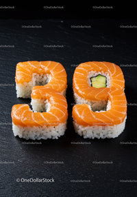 Salmon sushi shaped as number twenty nine on slate
