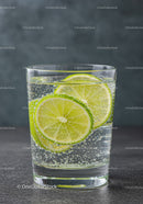 Sparkling water with fresh lime slices in clear glass