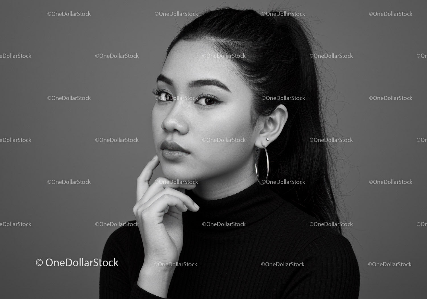 Elegant Black and White Portrait of a Woman with Hoop Earrings