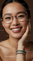 Smiling young woman with glasses and beaded bracelets
