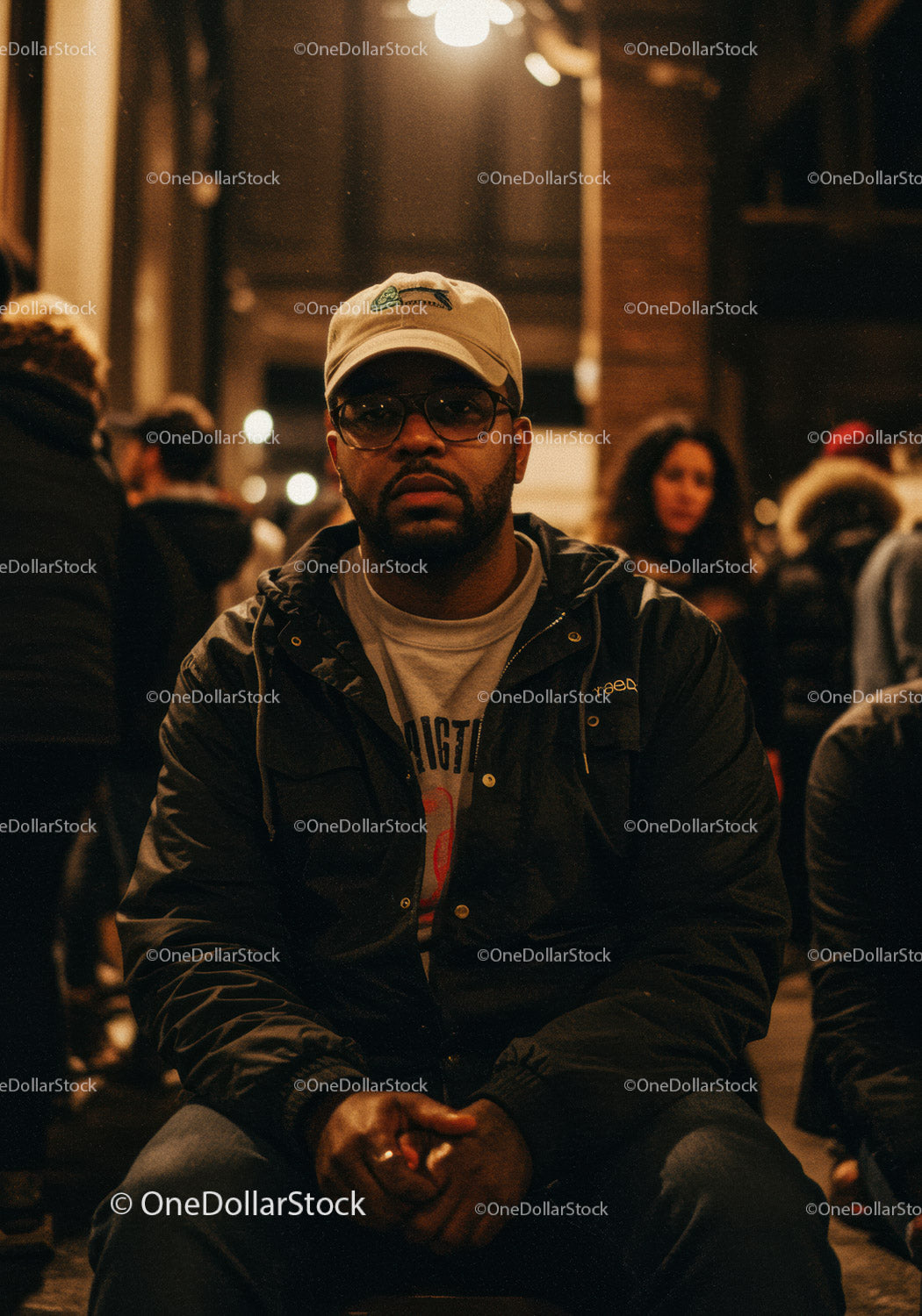 Man in casual wear sitting thoughtful in urban night