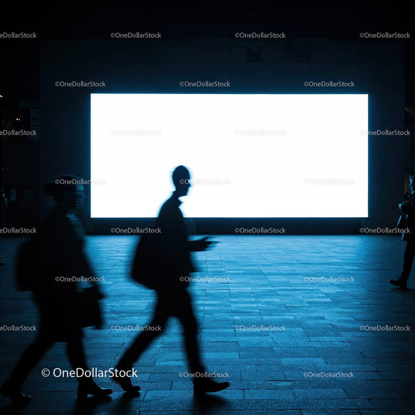 Silhouettes walking past bright urban billboard at night JPG Mockup Image