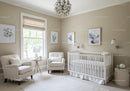 Elegant Nursery Room with White Crib and Botanical Wall Art