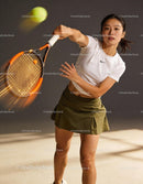 Focused female tennis player hitting a fast ball