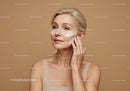 Mature Woman Applying Skincare Cream in Skincare Routine