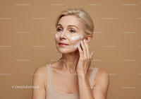 Mature Woman Applying Skincare Cream in Skincare Routine