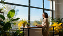 Relaxed woman enjoying sunlight near office window