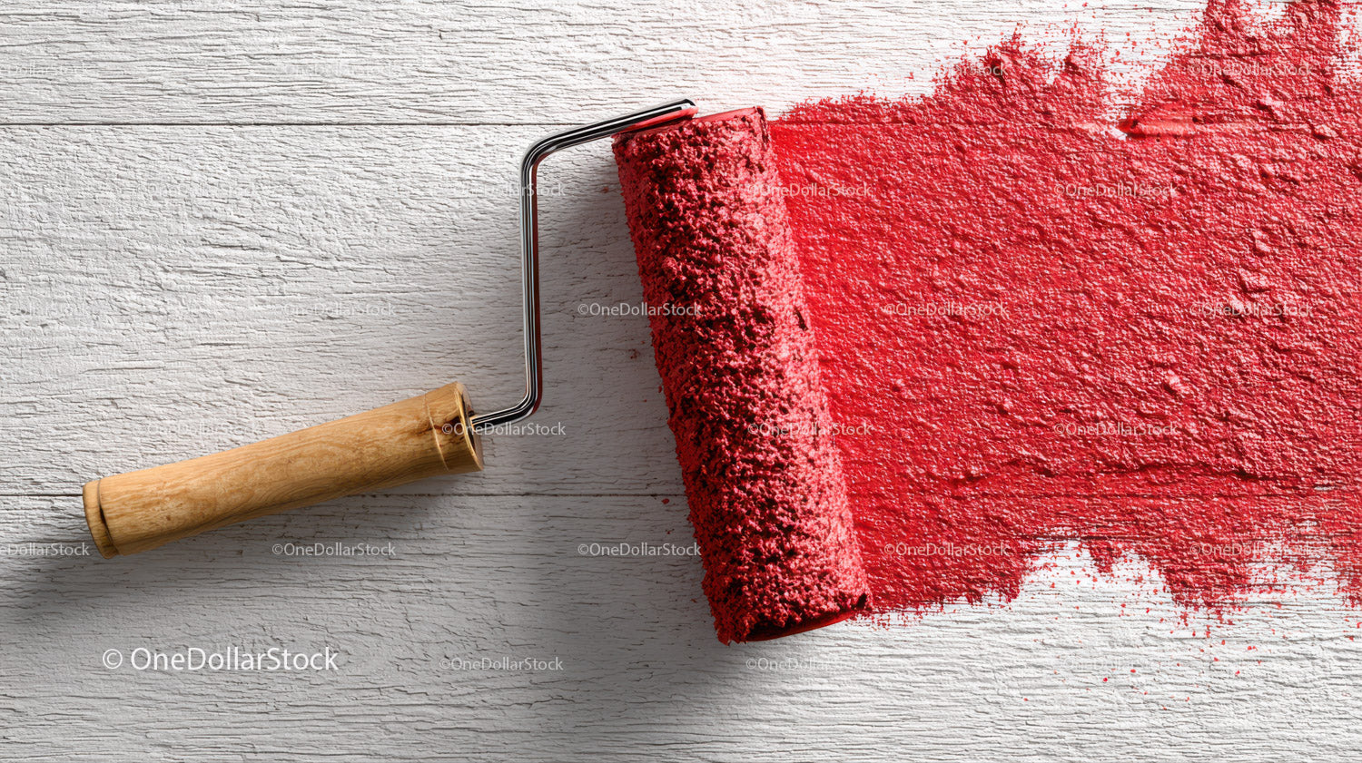 Red Paint Application with Roller on White Wooden Surface