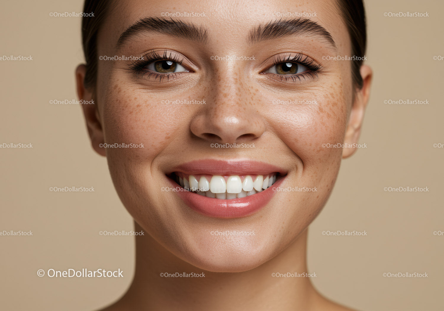 Close-up of smiling young woman with freckles and natural skin